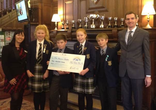 Worksop College Prep School Headmaster and students present charity donation to Aurora Wellbeing Centres.