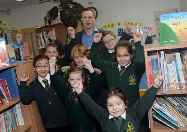 Children at Marton Primary School celebrate a good Ofsted report with head teacher Ben Stephenson