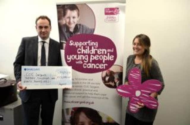 David Plumtree, chief executive of Sequence, presents a cheque to Lucia Martinez from CLIC Sargent