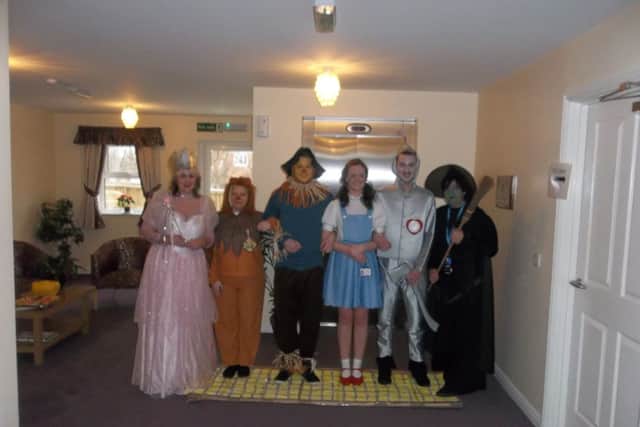 Staff dressed as characters from the musical