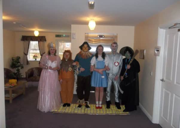 Staff dressed as characters from the musical