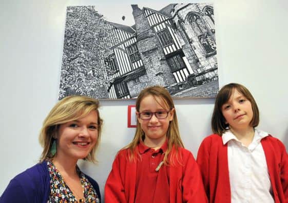 Children at Parish Church School have been working with photographer Charlotte Newton taking photographs of familiar sights from different viewpoints. The school put on an exhibition of the children's work. Photographer Charlotte Newton is pictured with some of the pupils
(NGAS-14-02-14 RA 3e)