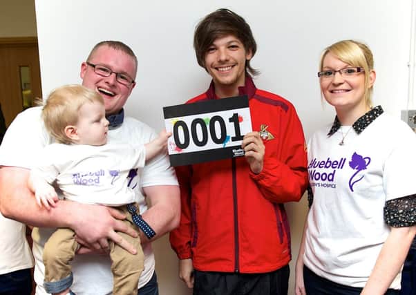 One Direction star Louis Tomlinson with Harrison and his parents Adam Elmer and Sam Baker. Photo by Antony Oxley