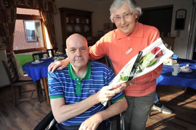 Guardian Rose presentation to Betty Barrowcliffe, Betty is pictured receiving her rose from Westwood Residential Home resident Ronald Crookes (NWGU-13-02-14 RA 3a)