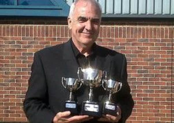 Alan Needham pictured before his diagnosis with trophies for music