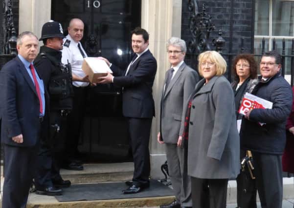 John Mann MP (left) and Bassetlaw councillors deliver the petition to Downing Street