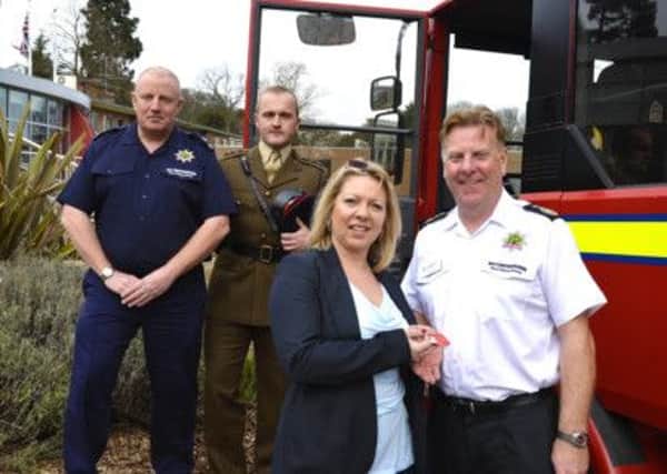 Sue Dye from Asset Advantage hands the fire engine keys to chief fire officer Frank Swann, with watch manager Kevin Ruane and Captain Jonathan Slegg