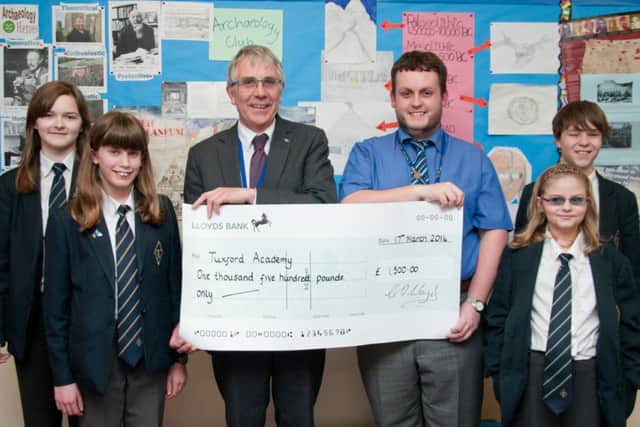 Tuxford Academy principal Geoff Lloyd, tutor Matt Hollingworth and students with their funding cheque