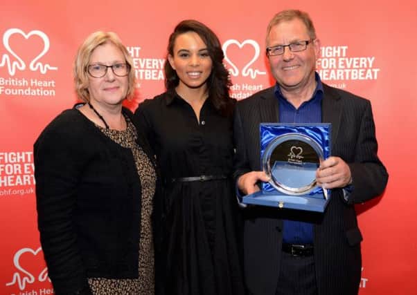Jenny and Fraser Britton receive their BHF award from international athlete Louise Hazel