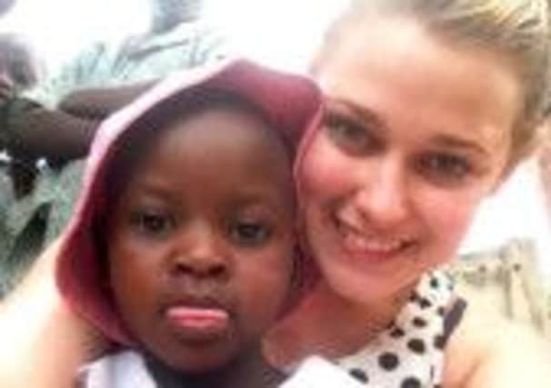 Olivia Johnson with a young friend in Uganda.