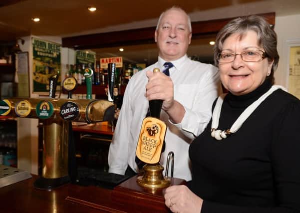 Barry and Beryl Tonkinson, of The Cross Keys, Wroot, are celebrating after being  awarded the CAMRA Pub of the Season for Autumn/Winter.  Picture: Liz Mockler E1482LM