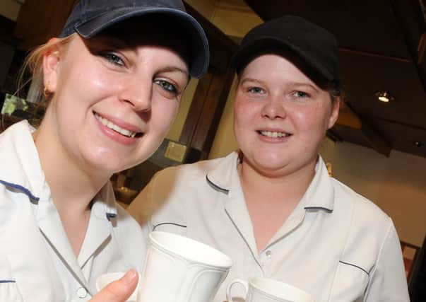 Sarah Shaw and Jodie Churm, of Holmes and Gardens. Epworth with a cup of coffee, which is on offer. Picture: Andrew Roe