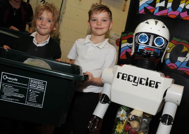 Jack Jerry and Roxy Bradley of St Martin's Primary School, Owston Ferry with a Recycler the recycling robot. Picture: Andrew Roe