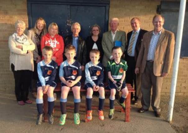 Members of the Parish Council and some young footballers outside the sports pavilion