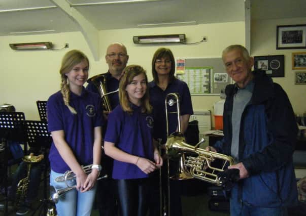 Coun John Swift presents some new instruments to members of Thurcroft Welfare training band