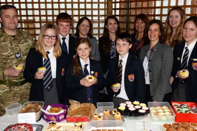 Staff and service chidren picturedalong with representatives from RAF Scampton during the Colossal CAke sale at Queen Elizabeth's High School. Picture: Marie Caley NGAS Help Heroes MC 3