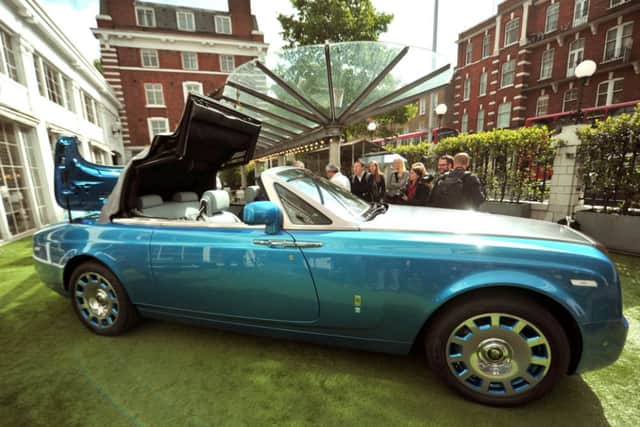 People view the new Rolls Royce Waterspeed Phantom Drophead Coupe, of which only 35 will be made, during its launch at the Bluebird Cafe, Campbell's original workshop, London. PRESS ASSOCIATION Photo. Picture date: Tuesday May 13, 2014. Photo credit should read: Anthony Devlin/PA Wire