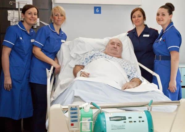 Patient Roy Murphy tries out of one of the new matresses, helped by nurses Louise Wall, Rhiannon Boddy, Tracy Vernon and Kelly Moore