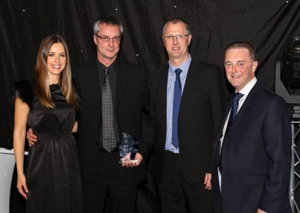 Stuart Morris and Andrew Steen from A1 Housing receive their AGSM Gas Safety Award from event host Charlie Webster (left) of Sky Sports and Chris Bielby (right), President of the AGSM