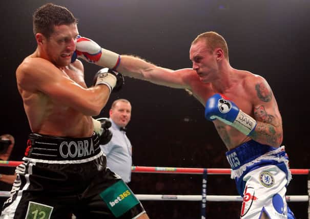 George Groves (right) punches Carl Froch during the WBA and IBF Super Middleweight Title fight at the Phones 4u Arena, Manchester.