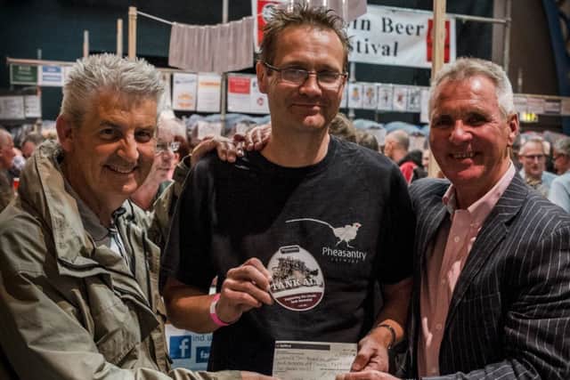 Mark Easterbrook presents the cheque to Frank Connell (left) and Joe Cooke. Picture: Stephen Richardson