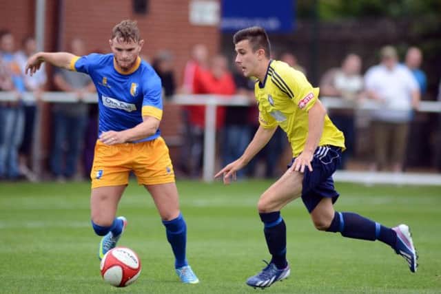 Worksop Town v Mansfield Town. Tigers player Conor Higginson and Mansfield player Ritchie Sutton G130710-4d