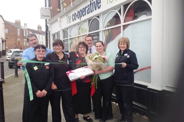 Wendy Kitson (centre) helps to officially re-open the Epworth Co-operative store, while her colleagues look on.