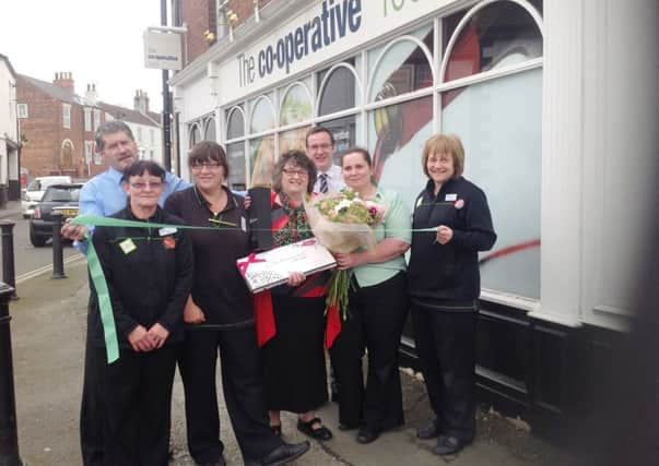 Wendy Kitson (centre) helps to officially re-open the Epworth Co-operative store, while her colleagues look on.