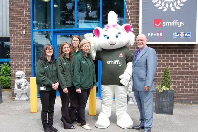 Welcoming new mascot Smiffy 9 Lives to the team are (from left): L.I.V.E.S team memmbers Kirsty Bembridge, Laura Dossor, Sara Newsam and Lindsey Fanning and Ray Peckett, managing director, Smiffy's