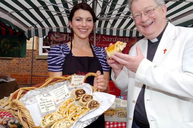 Epworth Food Fair. Rev Ian Walker from St Andrews Church tastes the goods on the Taste of Sardinia stall helped by Clare Eastwood (36). Picture: Malcolm Billingham