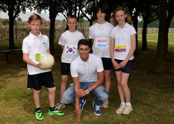 Whitwell Primary School held a football themed sports day with special guest Aston Villa footballer Matt Lowton. Pictured with Matt are pupils Lewis, Jaydan, Lucy and Julia