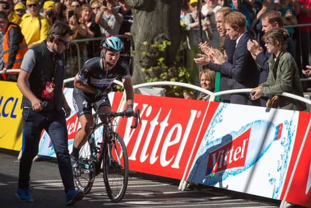 Crash injured Mark Cavendish applauded by The Duke of Cambridge and Prince Harry as he rides over the finish line in Harrogate. Photo: Tim Ireland/PA Wire