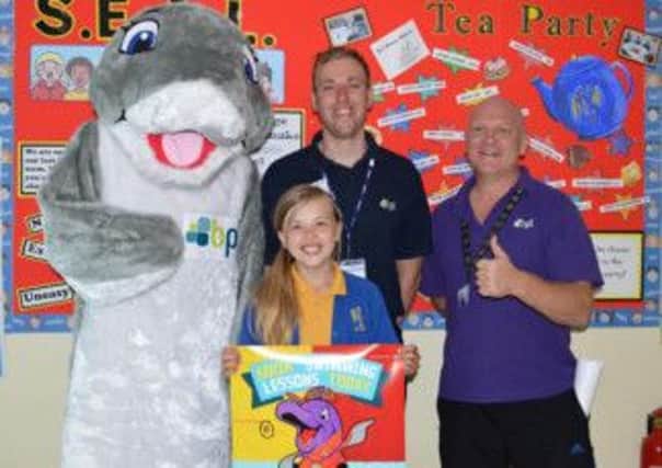 Competition winner Samantha Wright (eight) with campaign mascot Serek the Dolphin and Rob and Glynn from Worksop Leisure Centre