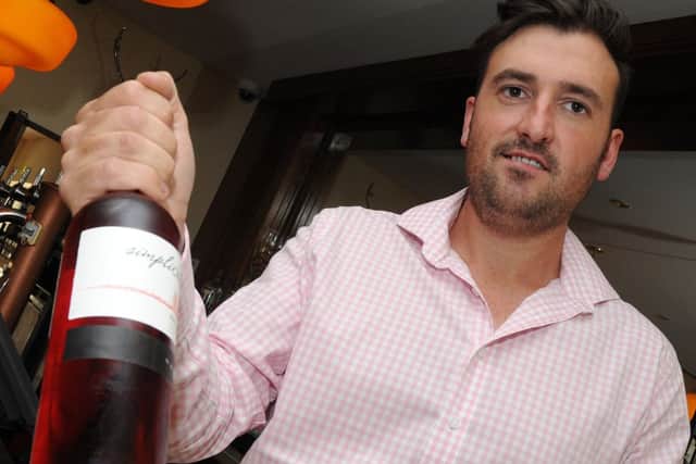 Matt Garner, of The Reindeer Inn with a bottle of wine which is on offer. Picture: Andrew Roe
