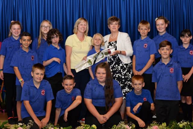 Michelle Pike and her daughter Ellie, 11, pictured presenting the Guardian Rose to Sue Osborn, Headteacher and some of the year six pupils. Picture: Marie Caley NWGU Prospect Hill MC 2