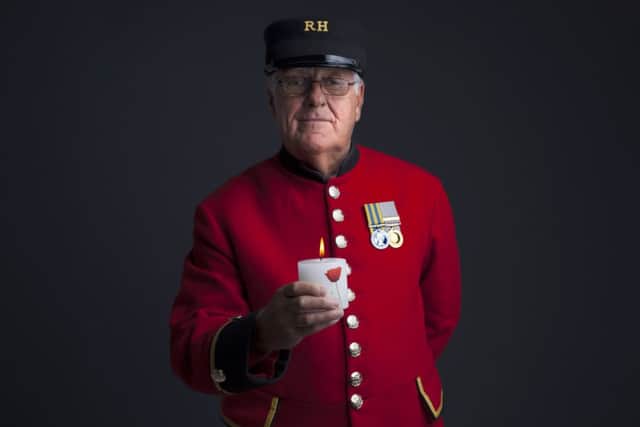 A veteran holds a candle to promote the national Lights Out campaign