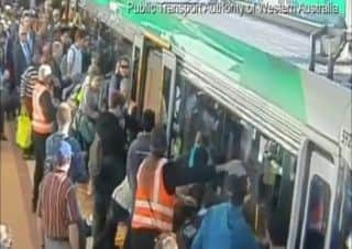 PASSENGERS TEAM UP TO TILT TRAIN OFF TRAPPED MAN IN AUSTRALIA
