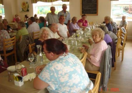 Pictured are members of the Isle of Axholme Physically Handicapped Society enjoying lunch with Lions president Graham Guest.