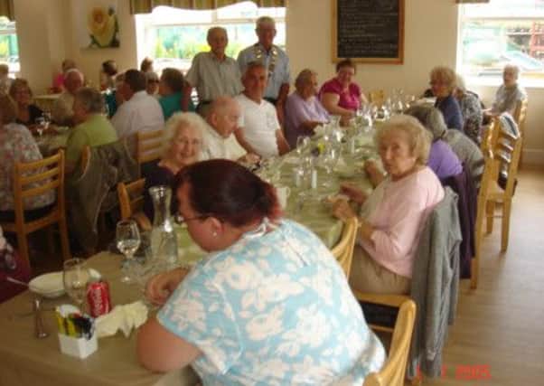 Pictured are members of the Isle of Axholme Physically Handicapped Society enjoying lunch with Lions president Graham Guest.