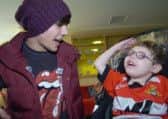 One Direction's Louis Tomlinson with Kian Critchley at Bluebell Wood Children's Hospice