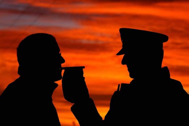 File photo dated 30/11/06 of a motorist stopped by police taking a breath test. Motorists are falling into the trap of thinking it is all right to drive after 'just a few' alcoholic drinks, according to an AA/Populus survey. PRESS ASSOCIATION Photo. Issue date: Monday June 24, 2013. Drivers in Northern Ireland and Wales are most likely to reckon they can handle the effects of a few drinks. See PA story TRANSPORT Drink. Photo credit should read: John Giles/PA Wire