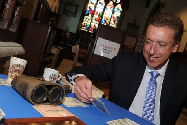 Cllr David Robinson looks at world war one memoriablia at an exhibition at St Andrew's Church, Epworth. Picture: Andrew Roe