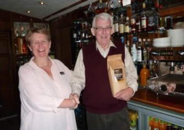 Kate Firth,general manager at Ye Olde Bell receives the first beans from Stewart Falconer of Stewart's of Nottingham after the installation of the new coffee-making equipment in the hotel