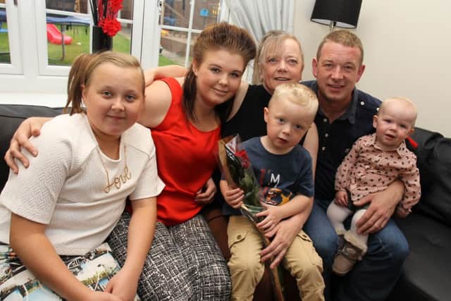 Beverley Spolander is presented with The Guardian Rose by Shannon Rushton, 15, and family members. Pictured with Beverley are Caitlyn Gray, 11, Shannon Rushton, 15, Callum Gray three, Robert Gray, and Georgia Gray, one.