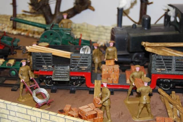 Men unloading a train on the model at the Lest We Forget World War One exhibition currently at Misterton library