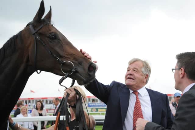 SIR MICHAEL STOUTE (centre), who trains today's Tip Of The Day (PHOTO BY: Anna Gowthorpe/PA Wire).