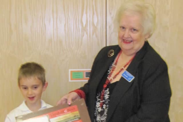 Ben Richardson, 8, being presented with his prize by JCH Charities Fund Chairman, Brenda Allen.