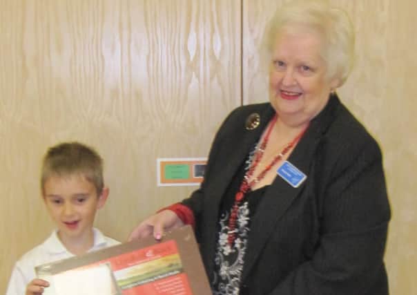 Ben Richardson, 8, being presented with his prize by JCH Charities Fund Chairman, Brenda Allen.