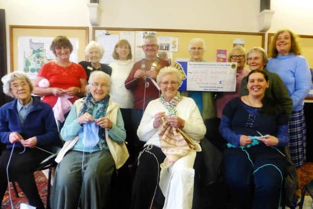 Isle of Axholme Lions President Graham Guest pictured with the Wesley Knitters.