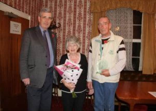 Brigadier Brown (left) president of the Worksop branch of the British Legion, makes a presentation to Shriley and Brian Madden following their retirements as secretary and chairman respectively